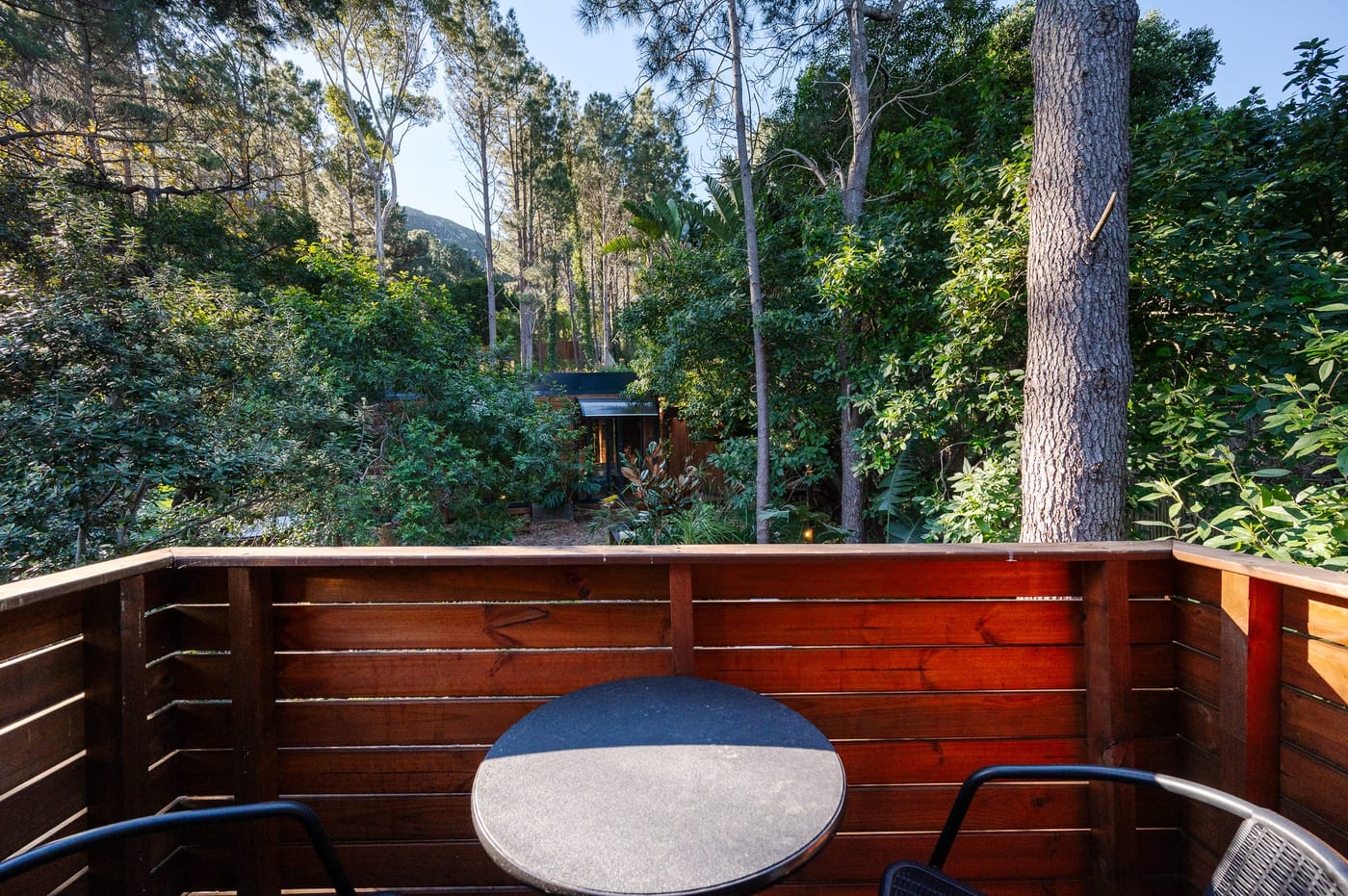 A table for two on the private balcony, looking into the forest