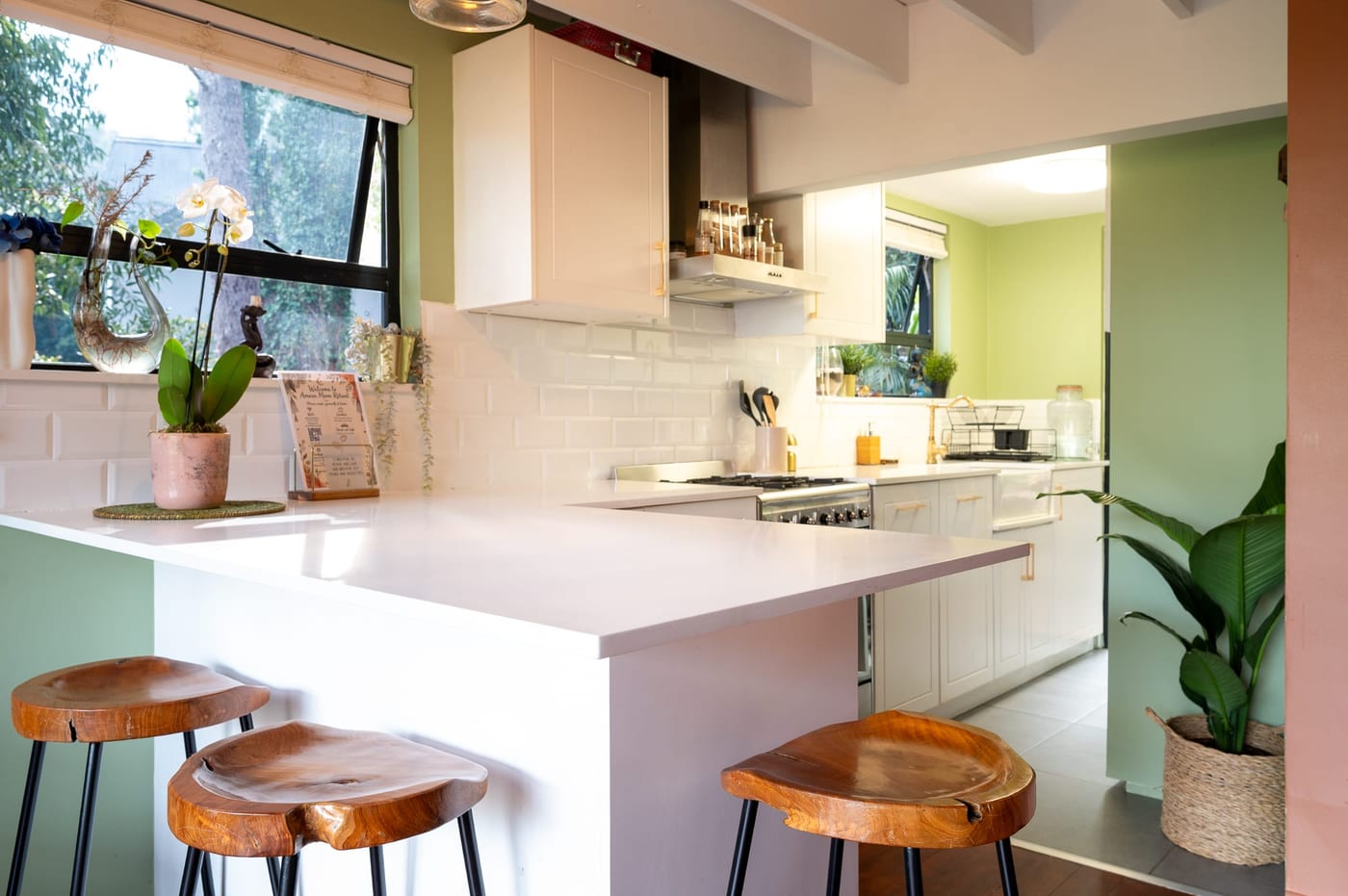 The counter close up — orchid, subway tile and a welcome card for guests