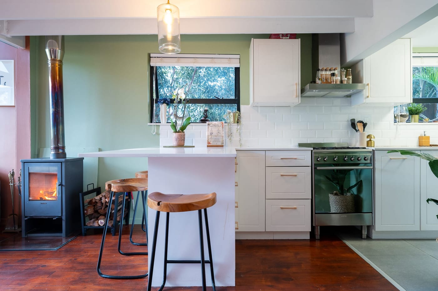 The island head-on, an orchid on the counter and the gas range behind