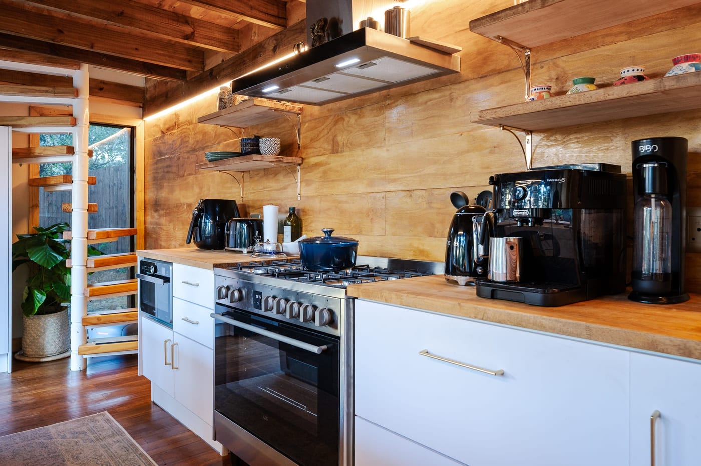 The gas range and coffee station, spiral stair to the loft alongside