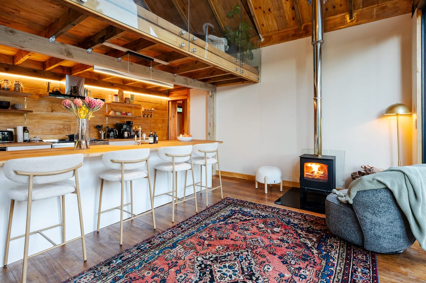The stove lit beside the island, a felted beanbag pulled up to the warmth