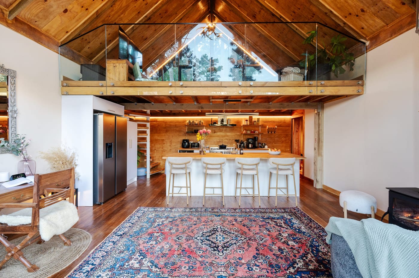 The full height of the A-frame, glazed gable and loft above the island