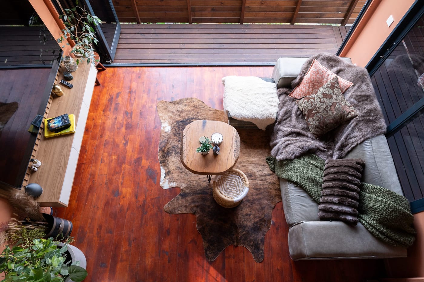Looking straight down from the mezzanine onto the sofa and live-edge table
