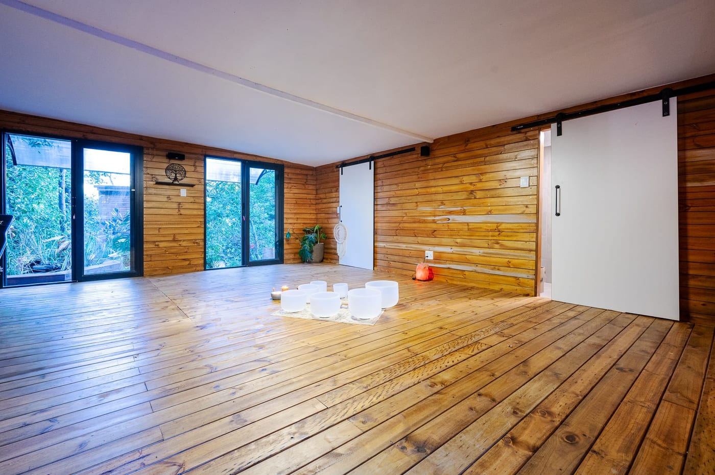 The Oasis Studio, crystal singing bowls and a salt lamp on wide timber floors